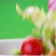 Fresh salad falling into bowl on green background - VideoHive Item for Sale
