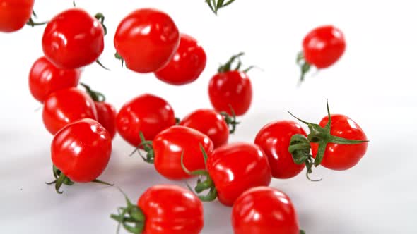 Super Slow Motion Shot of Cherry Tomatoes Falling on White Background at 1000Fps