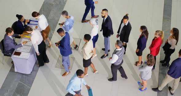 Business people checking in at conference registration table 4k