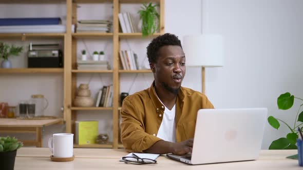 African American Man Makes Surprised and Happy Smile Emotion After Reading Good News Spbas