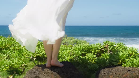 Slow Motion Closeup of Barefoot Woman in Beautiful Waving White Dress at Beach