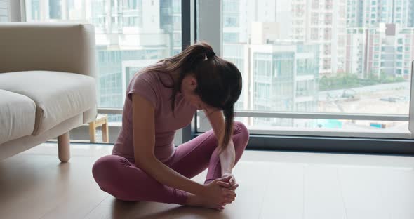 Woman stretch legs at home