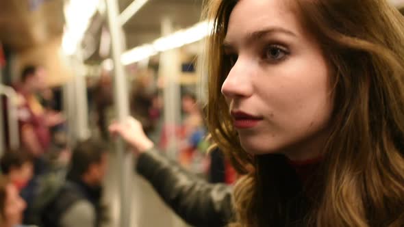 Young beautiful caucasian woman commuter in the subway