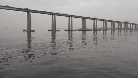 Vehicles Driving At Rio Niteroi Concrete Bridge Spanning Guanabara Bay In Brazil. - wide shot