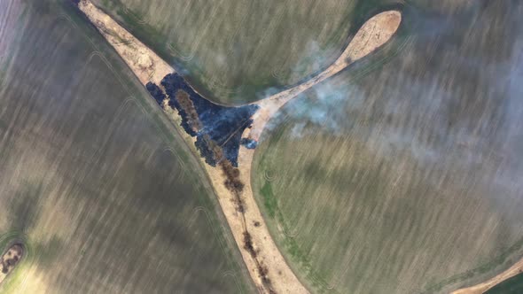 Bartinney Nature Reserve Grass fire. Drone Fly over Wild fire. Flying above burnt field.