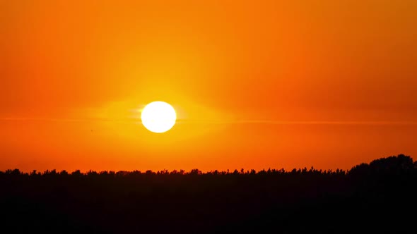 Sunset in the Yellow Sky. Timelapse. Big Bright Yellow Sun Moves Down.