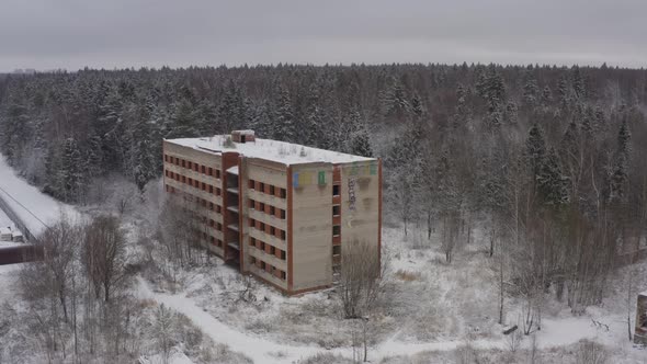 an Abandoned Multistorey Building From the Times of the USSR in a Dense Forest in a Winter Landscape