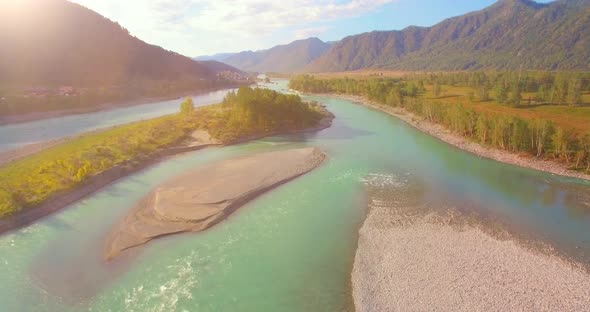 Low Altitude Flight Over Fresh Fast Mountain River with Rocks at Sunny Summer Morning