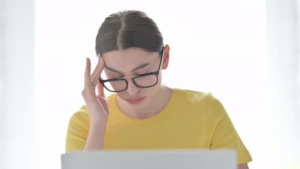 Portrait of Woman having Headache while using Laptop