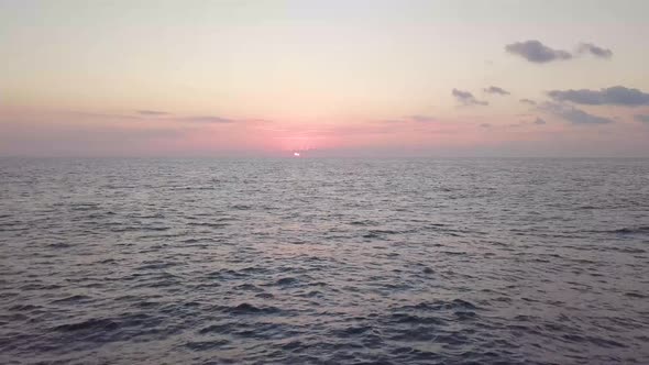 A beautiful clip of pink and gray hues over the sun rising over the Mediterranean sea just off the J