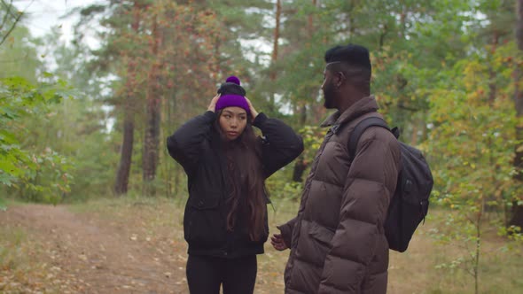 African Traveler Encouraging Tired Woman on Hike