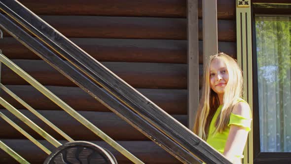 Beautiful Smiling Teen Girl Walking Up Wooden Stairs