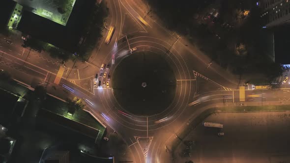 Illuminated Traffic Circle in the City and Cars Traffic at Night