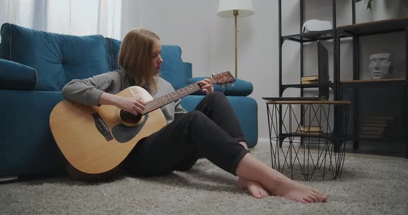 Beautiful Woman Is Sitting on the Floor in the Room