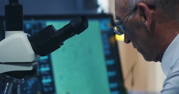 Scientist Examining Bacteria with Microscope alt