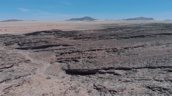 Aerial top view of African savannah hills, large red granite boulders range in Namibia