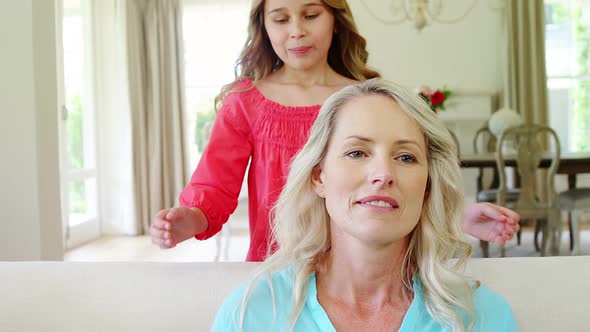 Girl embracing her mother in living room