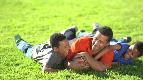 Group portrait of a father and his sons with a football