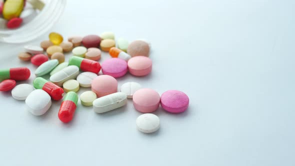 Close Up of Many Colorful Pills and Capsules on White Background