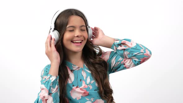 Happy Kid Enjoying Music Listen Her Favorite Song in Headphones and Dancing Music