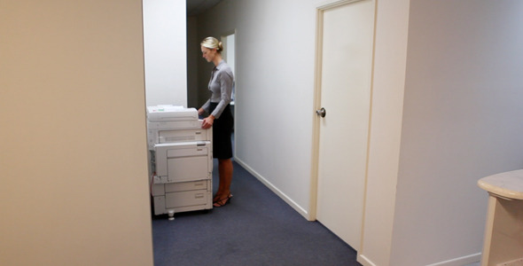 Girl Standing at Photocopier
