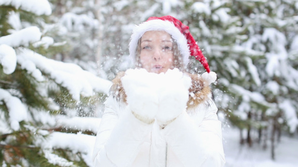 Friendly Woman Blowing Snowflakes
