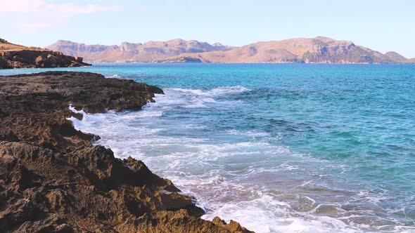 View of rocks on the coastline, sea and mountains in Majorca