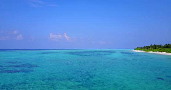 Daytime above island view of a white sand paradise beach and aqua blue water background in high reso