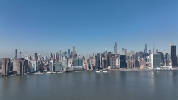 A high angle, aerial view of the Eastside of Manhattan from over Long Island City, NY on a sunny day