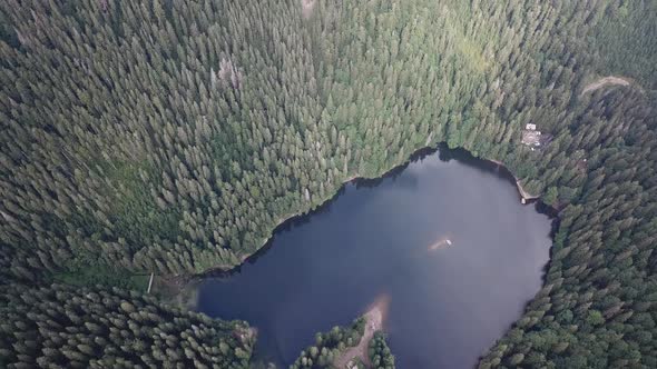 Beautiful mountain lake in the middle of the forest - top down view