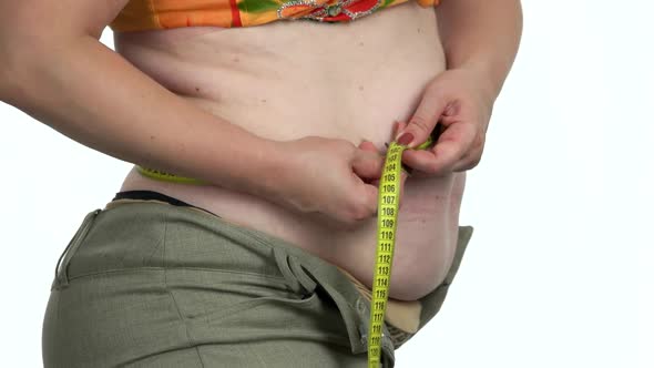 Obese Woman Measuring Her Belly with Tape Measure