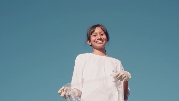 Young Female Volunteer Showing Thumbs-Up