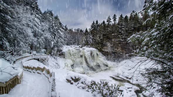 Cinemagraph of Blackwater Falls in winter with ice and snow while snowing heavily.
