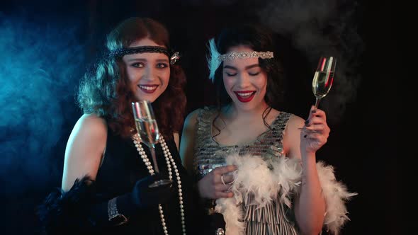 Charming Women Dressed in Style of Roaring Twenties Drinking Champagne, Celebrating New Year or