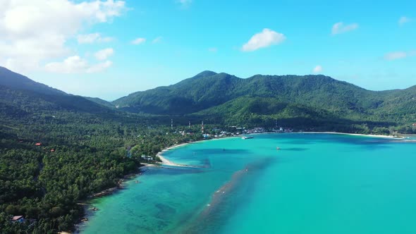 Aerial tourism of relaxing resort beach trip by aqua blue ocean with white sandy background of a day