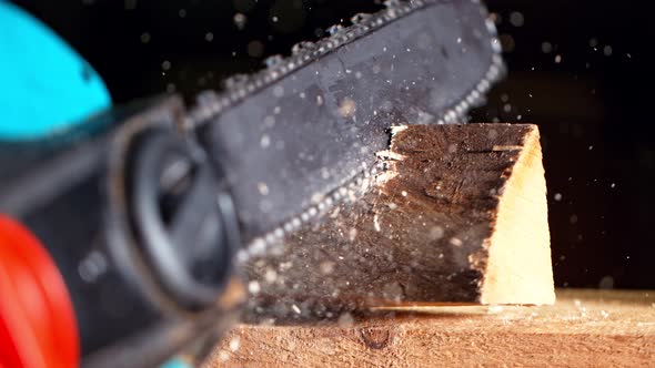 Super Slow Motion Detail Shot of Cutting Wood with Chainsaw at 1000 Fps