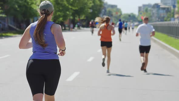 Plus Size Woman Running Marathon and Checking Pulse
