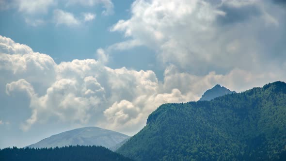 Clouds above Green Forest Mountains Landscape in Spring Nature