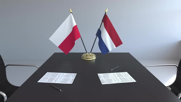 Flags of Poland and the Netherlands on the Table