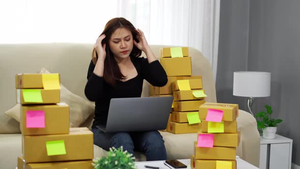stressed woman entrepreneur working with laptop computer and has problem to selling product online