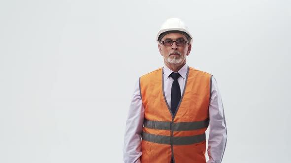 Studio Portrait Mature Man in Eyeglasses Middle Aged Engineer Shows Index Finger to the Side