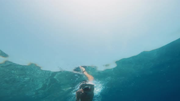 Swims Freestyle in the Ocean in the Ocean Underwater View