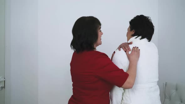 Woman Therapist Examines Mature Patient Painful Shoulders