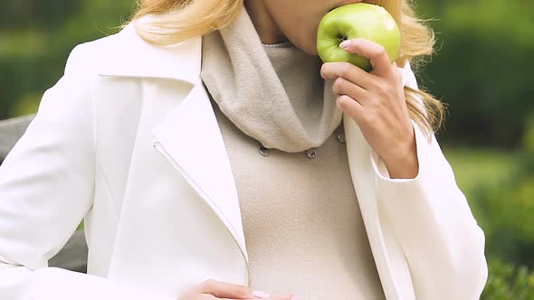 Pregnant Female With Big Belly Biting Apple, Suffering Toxicosis, Feeling Sick