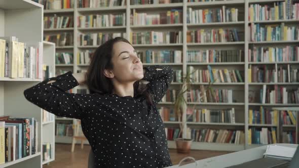 Young Happy Businesswoman Relaxing Resting in Office Library