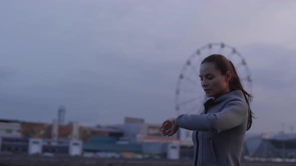 Beautiful Woman Using Smartwatches and Running in City