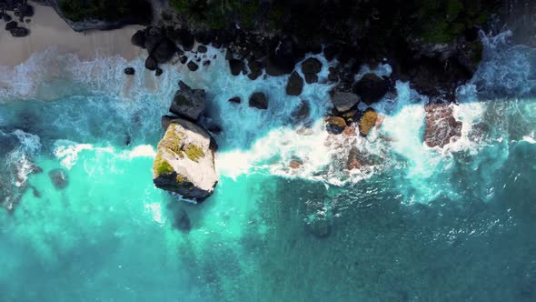 Top Down View on Hidden Sandy Beach with Azure Water