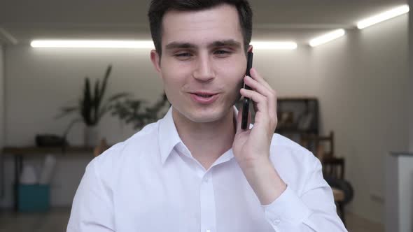 Businessman Talking on Phone in Office