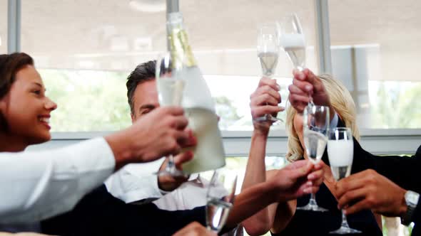 Group of smiling friends toasting champagne glass