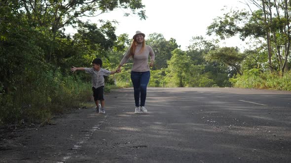 Slow motion, Mother and her son running in the street